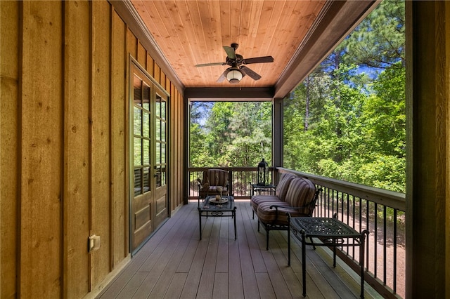 wooden deck featuring ceiling fan