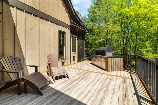 deck featuring exterior kitchen and a grill