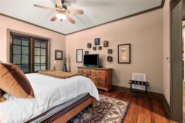 bedroom featuring ceiling fan, visible vents, crown molding, baseboards, and dark wood-type flooring