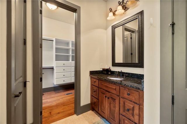 bathroom with vanity and wood finished floors