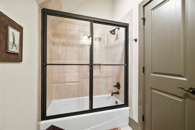 bathroom featuring bath / shower combo with glass door
