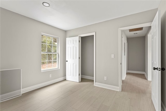 unfurnished bedroom with baseboards and light wood finished floors