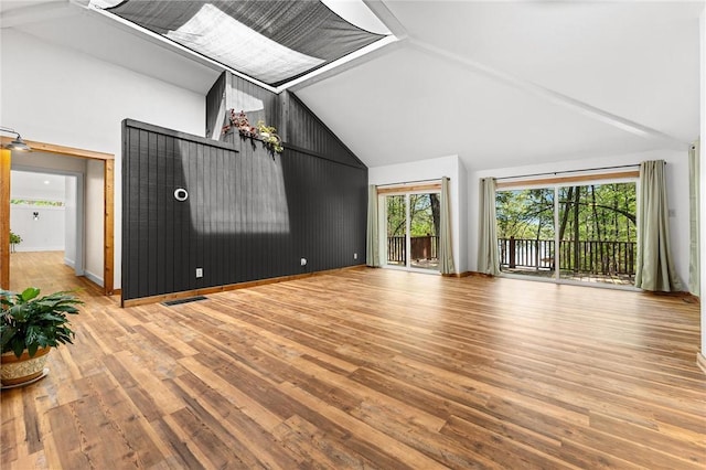 243 Beaver Lodge Rd, Hartwell, GA 30643 - unfurnished living room with wood finished floors, high vaulted ceiling, and baseboards