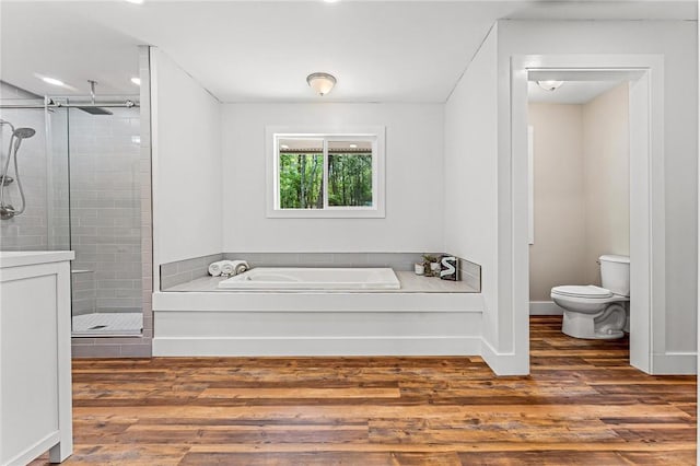 243 Beaver Lodge Rd, Hartwell, GA 30643 - bathroom featuring a shower stall, a garden tub, toilet, wood finished floors, and baseboards