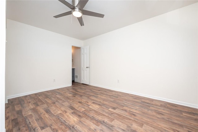 spare room featuring a ceiling fan, baseboards, and wood finished floors