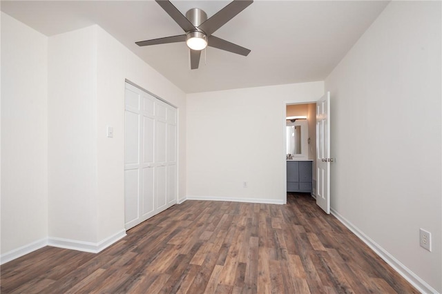 unfurnished bedroom featuring baseboards, ceiling fan, a closet, and dark wood-style floors