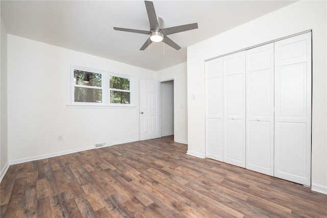 unfurnished bedroom featuring baseboards, visible vents, and wood finished floors
