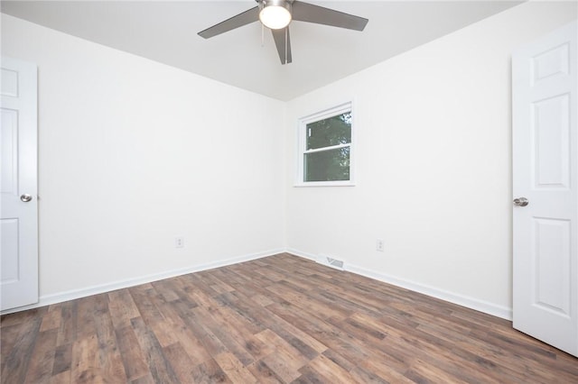 spare room featuring visible vents, baseboards, ceiling fan, and wood finished floors