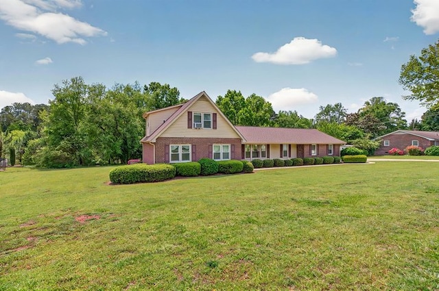 view of front of property with brick siding and a front lawn