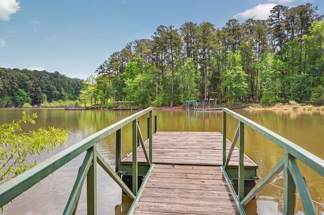 dock area with a water view and a forest view