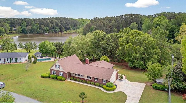 birds eye view of property featuring a water view and a view of trees