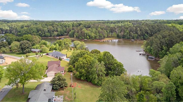 aerial view with a water view and a forest view