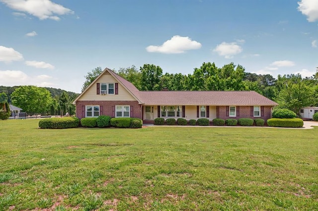 view of front of house with brick siding and a front yard