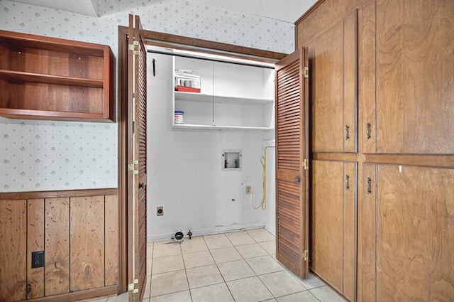 laundry area with laundry area, washer hookup, light tile patterned flooring, and wallpapered walls