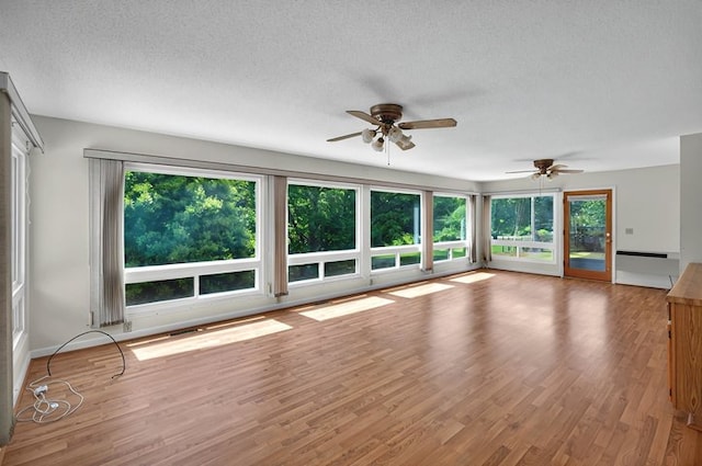 unfurnished room featuring ceiling fan, a textured ceiling, and wood finished floors