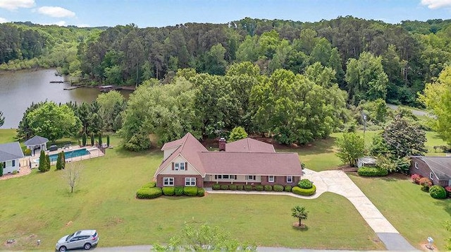 bird's eye view with a water view and a wooded view