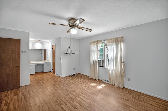 unfurnished bedroom with baseboards, ceiling fan, light wood-style flooring, and visible vents