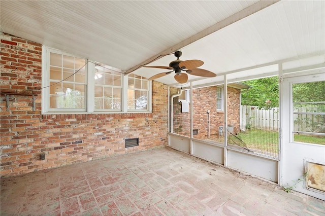 unfurnished sunroom featuring ceiling fan