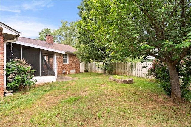 view of yard with fence and a sunroom