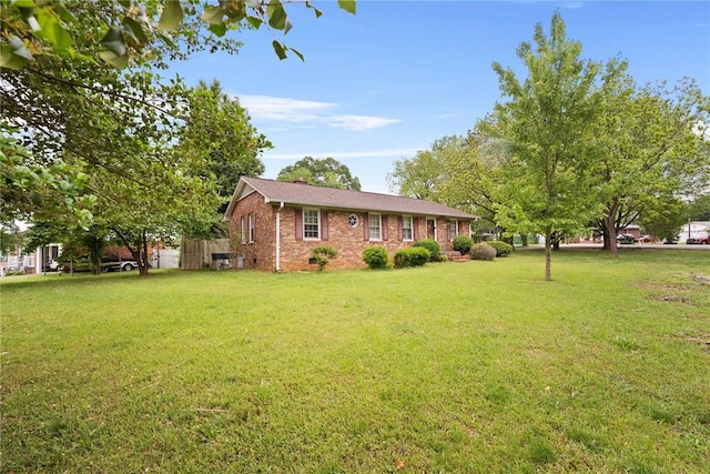 ranch-style home with a front lawn and brick siding