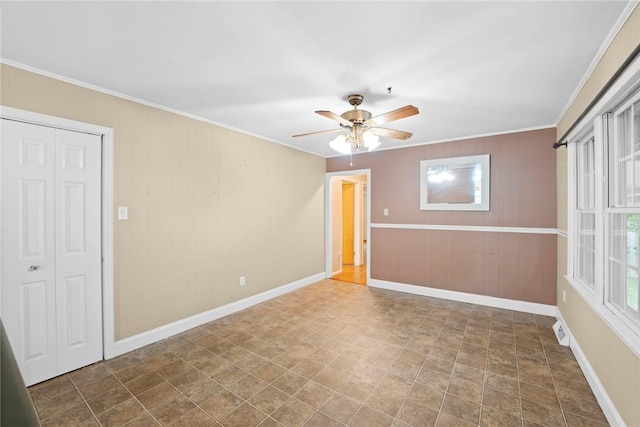 unfurnished room featuring crown molding, a ceiling fan, baseboards, and plenty of natural light