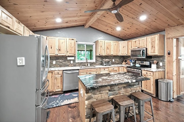kitchen with light brown cabinetry, dark wood-style flooring, appliances with stainless steel finishes, a sink, and vaulted ceiling with beams