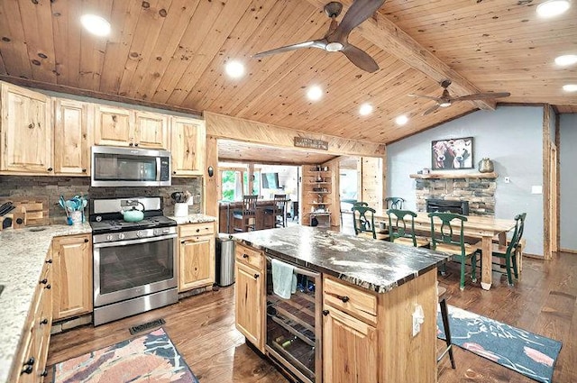 kitchen featuring a ceiling fan, wine cooler, wood finished floors, and stainless steel appliances