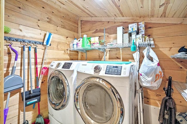 clothes washing area with separate washer and dryer, laundry area, wooden walls, and wooden ceiling