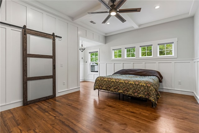 604 Robin Hood Ln, Anderson, SC 29621 - bedroom with visible vents, a barn door, a decorative wall, and beam ceiling