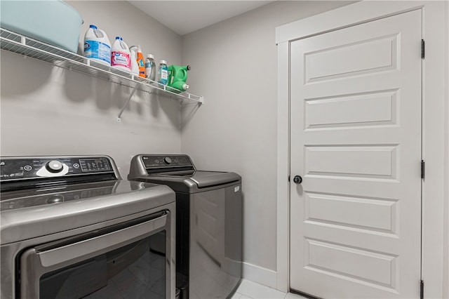 604 Robin Hood Ln, Anderson, SC 29621 - laundry area featuring light tile patterned floors, baseboards, laundry area, and washer and dryer