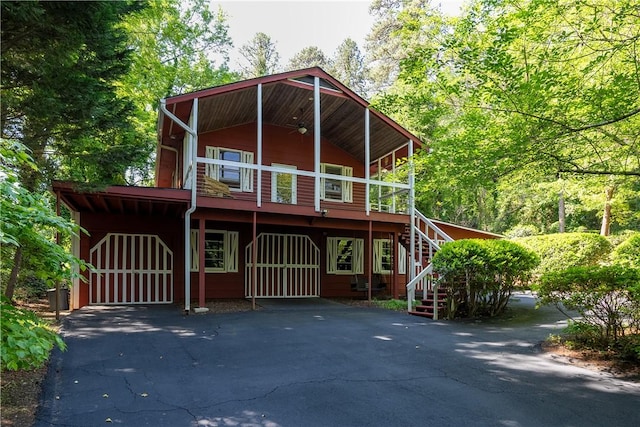 view of front of property featuring stairway and driveway