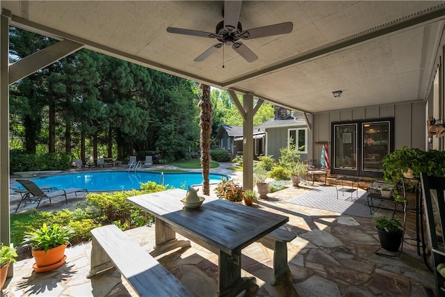 view of patio / terrace with ceiling fan and an outdoor pool