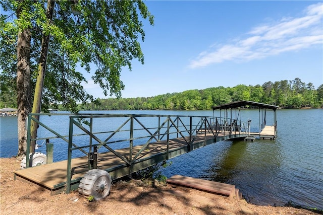dock area with a water view and a forest view