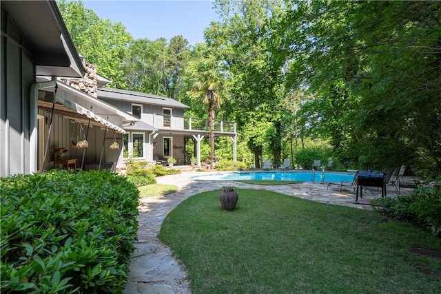 view of yard with a patio area and an outdoor pool