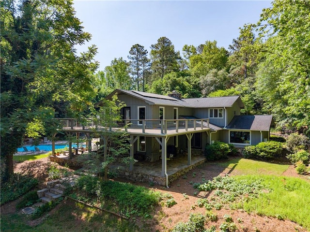 rear view of house featuring a patio area and a deck