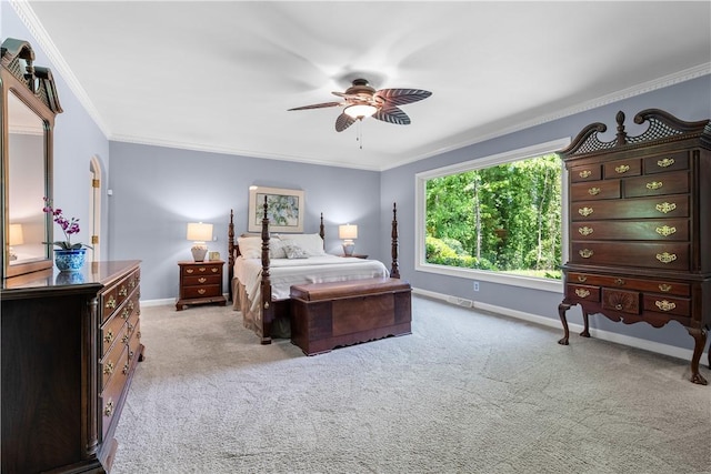 carpeted bedroom with crown molding, a ceiling fan, and baseboards