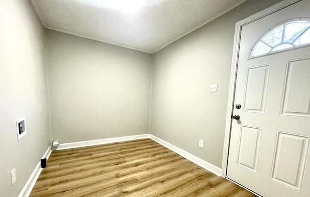 laundry area with laundry area, light wood-style floors, baseboards, and washer hookup