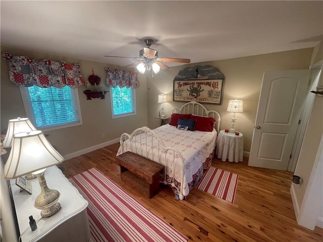 bedroom with baseboards, a ceiling fan, and wood finished floors