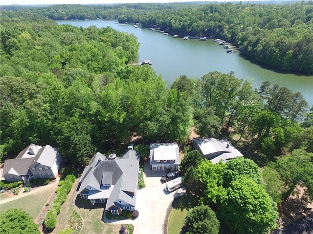 birds eye view of property featuring a view of trees and a water view