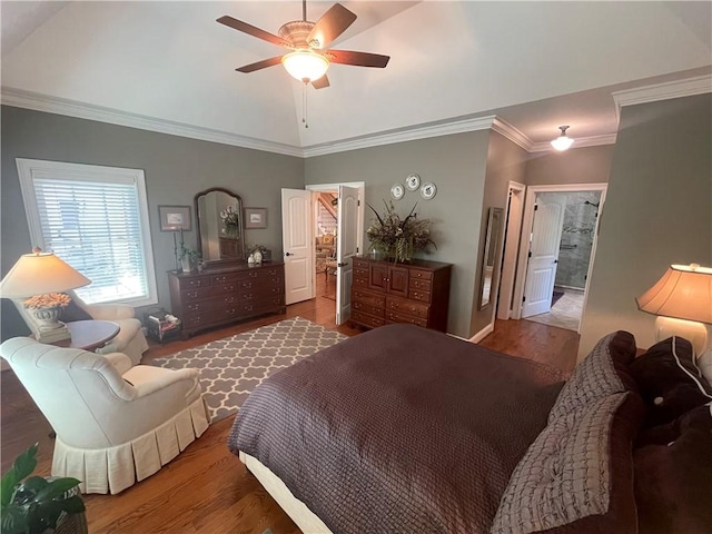 bedroom featuring ornamental molding, ceiling fan, wood finished floors, and vaulted ceiling