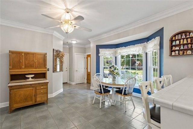 dining room with crown molding, light tile patterned flooring, ceiling fan, and baseboards