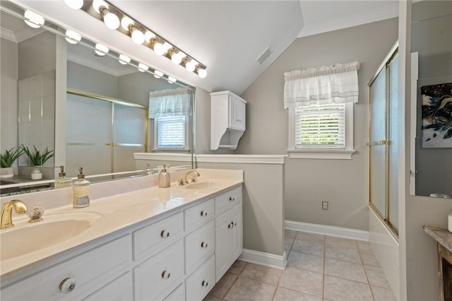 bathroom featuring crown molding, double vanity, vaulted ceiling, and a sink