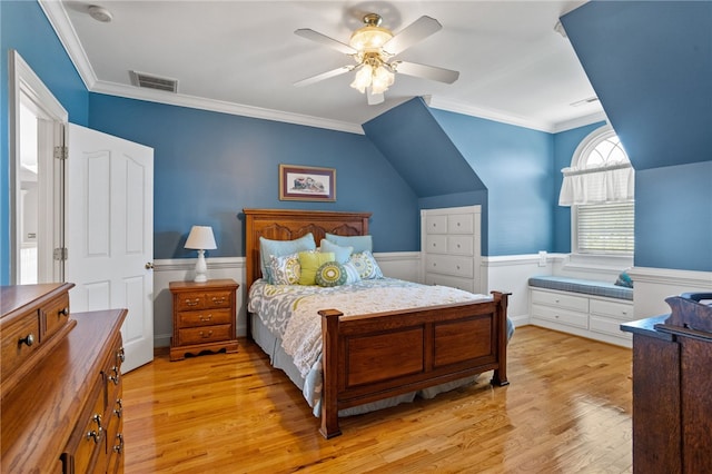 bedroom featuring visible vents, ornamental molding, and light wood-style flooring