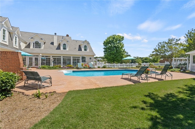 view of swimming pool with fence, a fenced in pool, french doors, a patio, and a yard