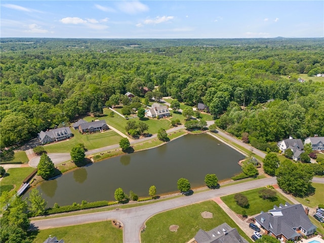 aerial view featuring a water view and a wooded view