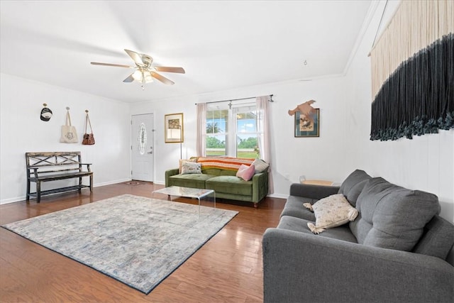 living room featuring baseboards, dark wood-style flooring, and ceiling fan