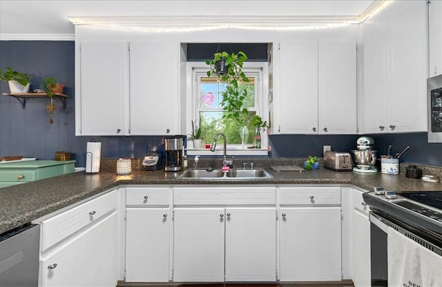 kitchen featuring a sink, white cabinetry, and dark countertops