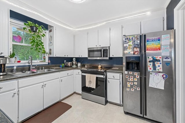 kitchen featuring a sink, white cabinetry, dark countertops, and stainless steel appliances