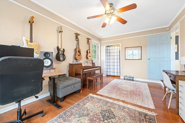 office area with baseboards, ornamental molding, ceiling fan, and wood finished floors