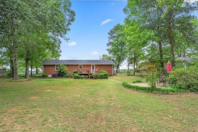 view of yard featuring fence and a deck